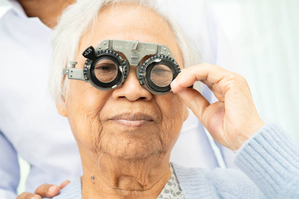 istock Optometrist checking Asian elderly woman ophthalmic vision eye test and using optical trial frame. 2187540631