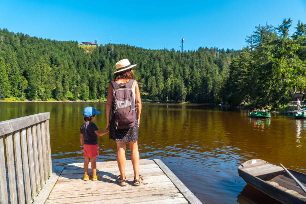 istock Mother and child in summer at Mummelsee, Black Forest, Germany 2187543387