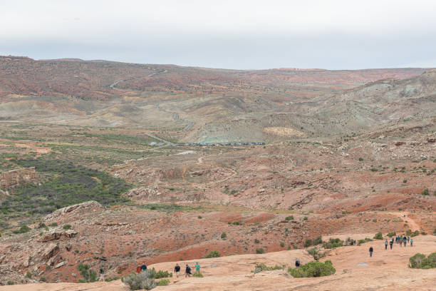 Utah, USA - May 20 2024;  Walkers on the Delicate Arches Trail in Arches National Park