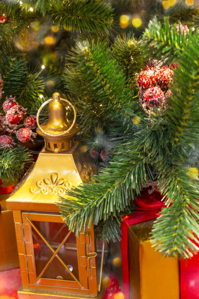istock Golden lantern and presents under Christmas tree 2187546341