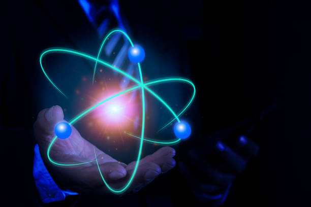 istock Bussinessman hand holding creative atom. Nuclear fusion concept, endless energy, cheap electricity, future technologies. Science and future concept 2187549460