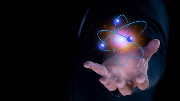 istock Bussinessman hand holding creative atom. Nuclear fusion concept, endless energy, cheap electricity, future technologies. Science and future concept 2187549461