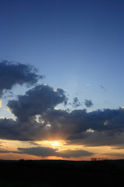 a sunset with clouds and a sun in the sky