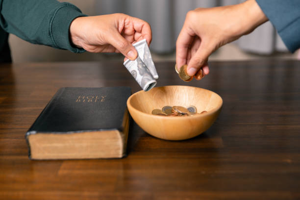 istock He decided to donate portion of his earnings as tithe, giving money and coins as contribution to support financial needs of community. beg, quest, request, desire, need, problem, share, charitable 2187551560