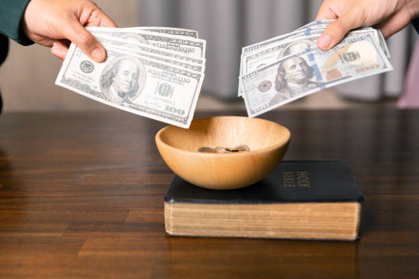 istock He decided to donate portion of his earnings as tithe, giving money and coins as contribution to support financial needs of community. beg, quest, request, desire, need, problem, share, charitable 2187551562