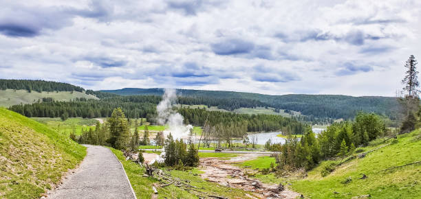 Mud volcano trail hiking in Yellowstone National Park, Wyoming Mud volcano trail view in Yellowstone National Park, Wyoming mud volcano yellowstone stock pictures, royalty-free photos & images