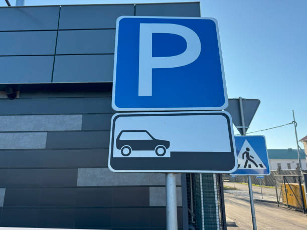 istock A parking sign indicating that cars can be parked with their front ends facing the sidewalk. The sign is positioned at the edge of the road 2187557787