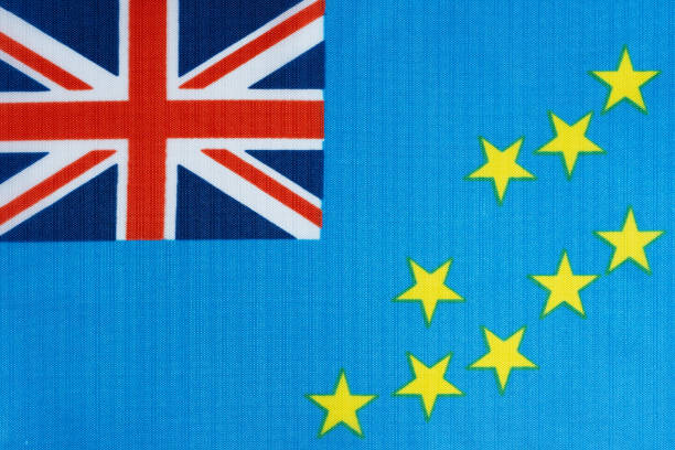 Avarua, Rarotonga, Cook Islands: the flag of the Cook Islands features a blue field with the Union Jack in the canton (upper left corner) and 15 white stars arranged in a circle in the fly (right portion). Adopted in 1973, the flag represents the nation's historical ties to the United Kingdom and New Zealand (through the Union Jack), while the stars symbolize the 15 main islands that make up the Cook Islands archipelago in the South Pacific. The blue background represents the Pacific Ocean that surrounds the islands, and the circle of stars represents the unity among the islands despite their geographical separation.