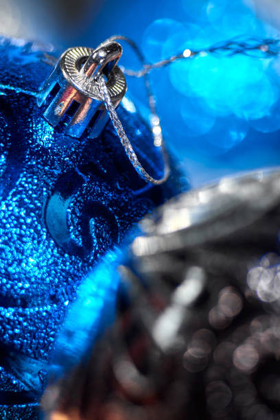 New Year's Christmas balls and decorations close up surface. Monochrome black white silver. Festive beautiful background