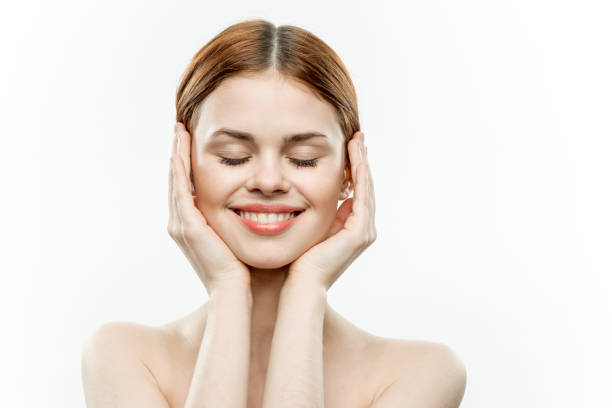 istock woman holding face closed eyes charm model 2187571558
