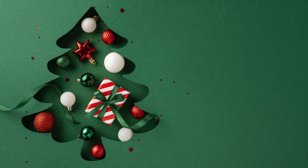 istock Creative Christmas tree design with ornaments and presents in a festive green setting, capturing the holiday spirit and celebration 2187575561