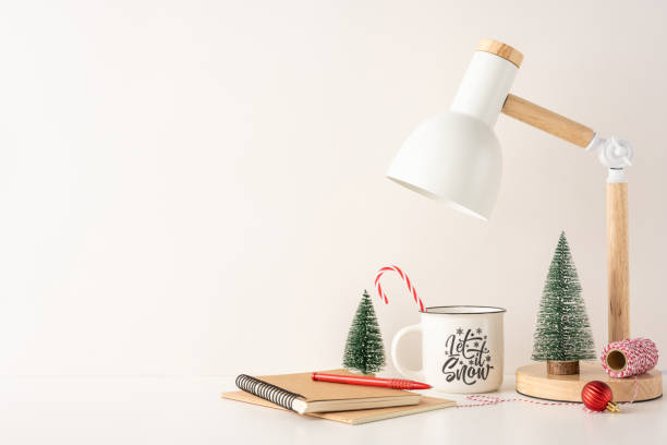 istock Minimal still life Scandinavian winter workspace featuring a mug with candy cane, small trees, and copybook 2187575571