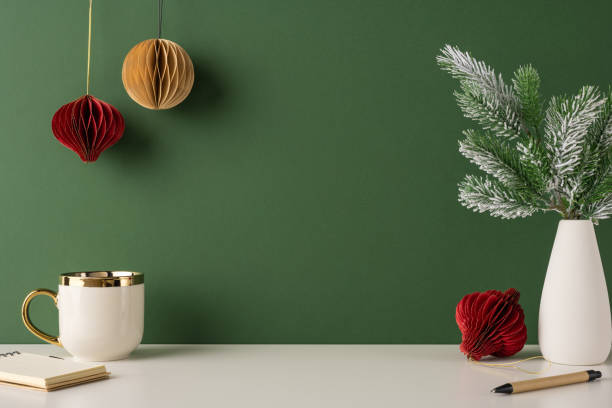 istock A side view minimalist Scandinavian style setup featuring a festive mug, hanging ornaments, and a frosted branch on a simple table 2187575598