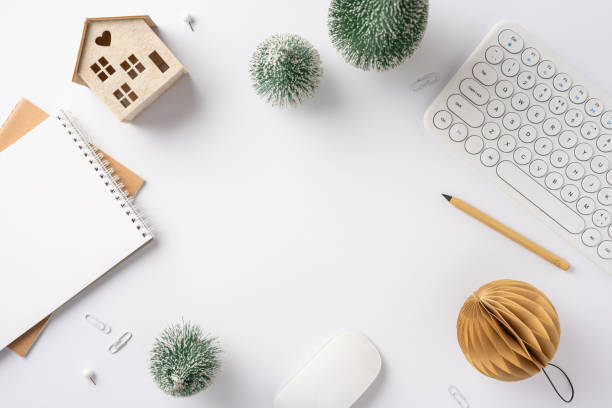 istock A clean and minimalist winter workspace featuring a keyboard, notebook, decorative trees, and office supplies, creating a cozy and festive atmosphere 2187575609