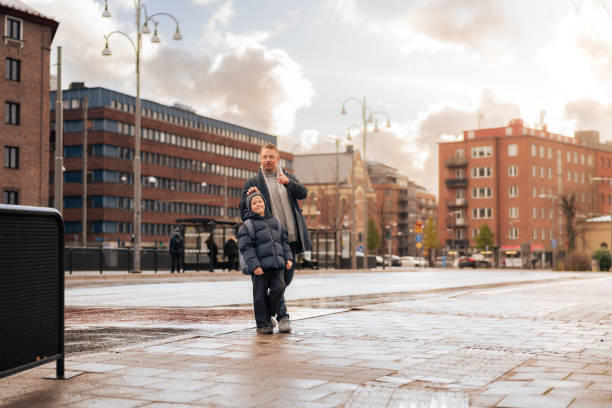istock Father pointing away to son while walking in Scandinavian city 2187576430