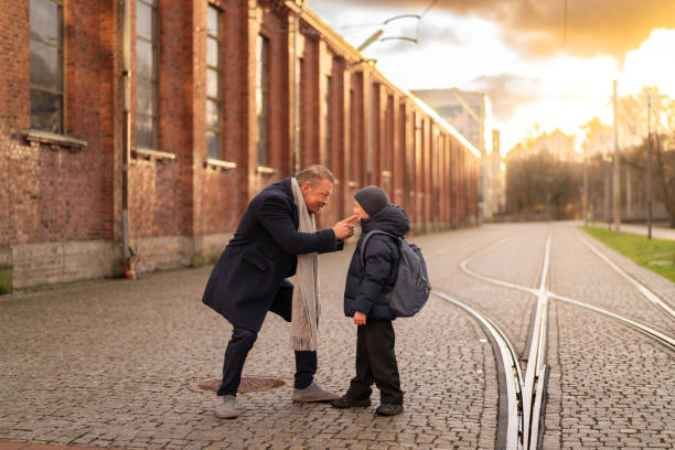 istock Father touching son's cheeks on tramway in Scandinavian city at sunset 2187576453