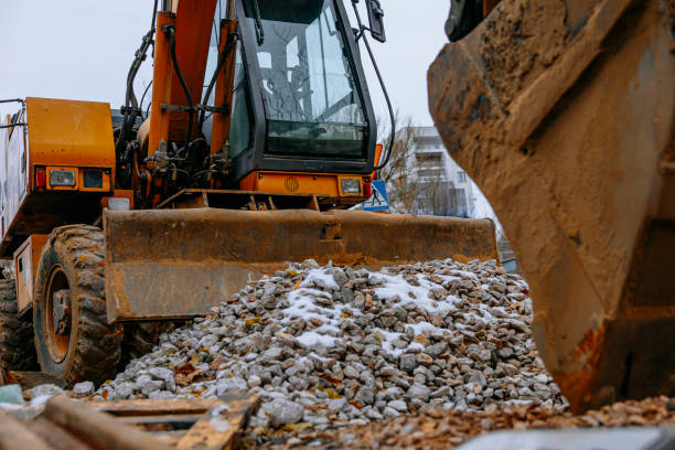 istock Excavator at a construction site moving gravel on a cloudy day 2187577038