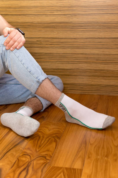 istock Men's legs in gray and white socks 2187579928