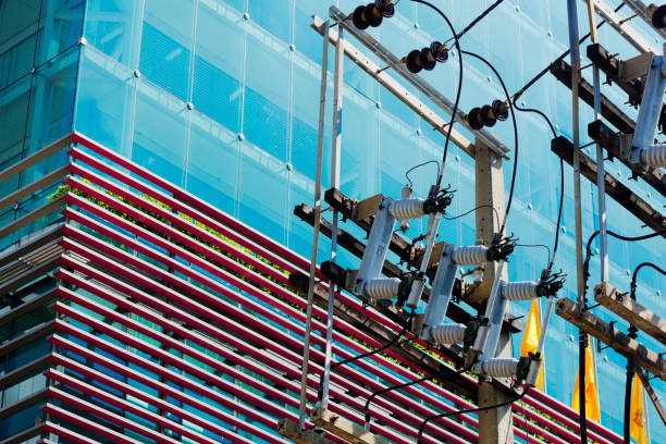 Electrical grid infrastructure  in front of modern office building in Bangkok Sutthisan