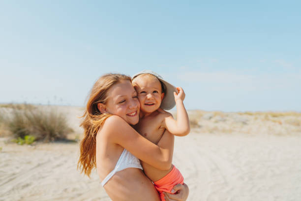 istock Brother and sister at the beach 2187582742