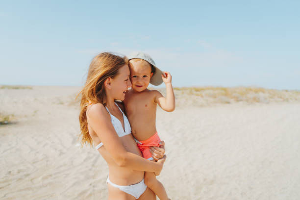 istock Brother and sister at the beach 2187582748