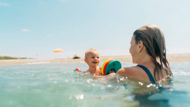 istock With my mommy in the sea 2187582791