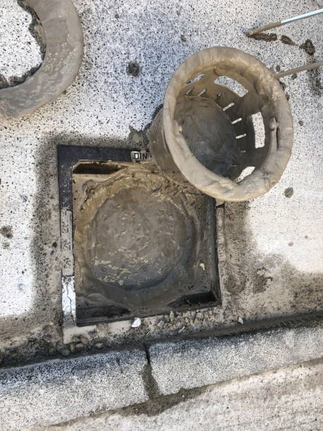 istock Street drain for rainwater is blocked by concrete sludge 2187584449