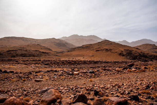 orange volcanic rocks and desert Atlas panorama in the mountains in the heights near Jebel Saghro between the desert and Marrakesh in Morocco