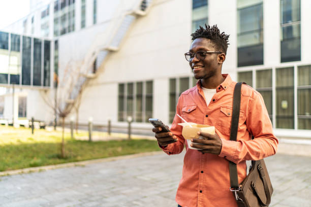 istock Young man having a lunch outdoors 2187587525