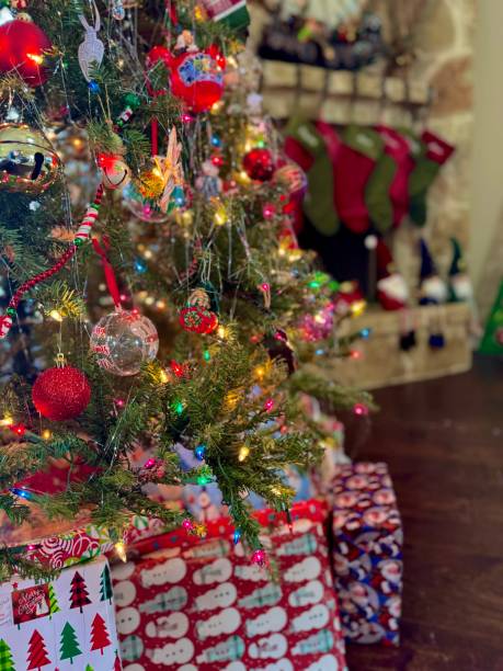 istock Traditional Christmas tree with presents and stockings on fireplace 2187588568
