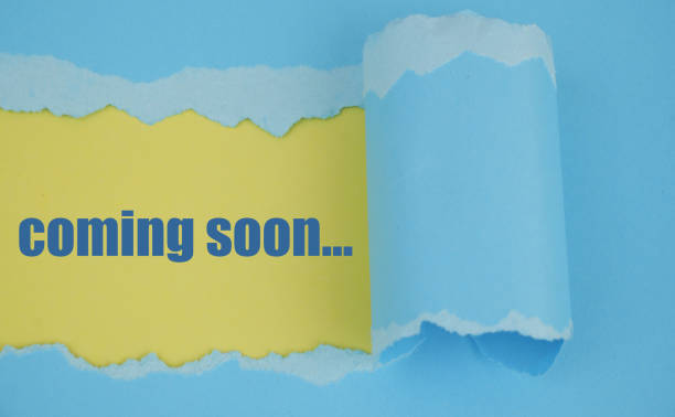 Blue paper torn with yellow background and words coming soon.