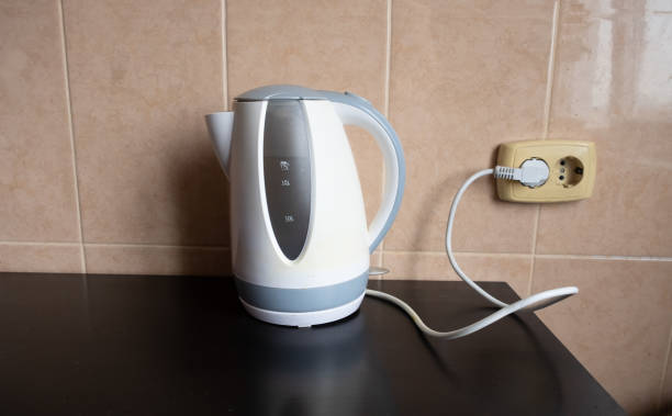 istock An electric kettle with water stands on the table in the kitchen, plugged into the socket 2187590537