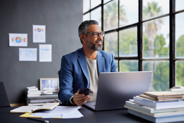 istock Pensive mature businessman thinking after a business call at work 2187591925