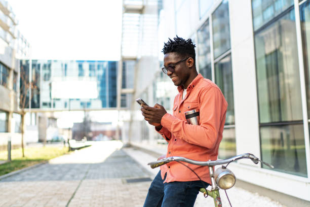 istock Smiling businessman using mobile phone in city 2187591991