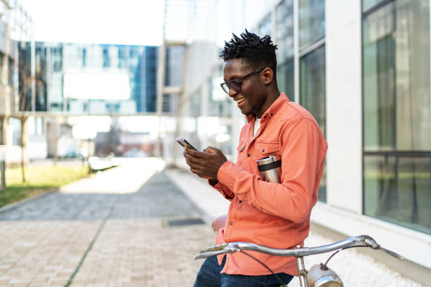 istock Smiling businessman using mobile phone in city 2187592003