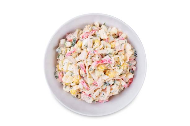 istock Imitation crab meat corn cucumber salad in a bowl on a white isolated background 2187592440