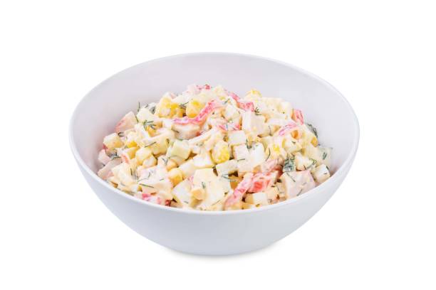 istock Imitation crab meat corn cucumber salad in a bowl on a white isolated background 2187592451