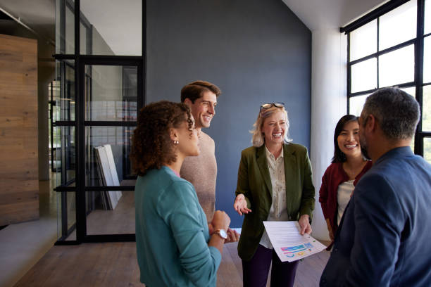 istock Happy multiethnic business team talking together in office lobby 2187592464