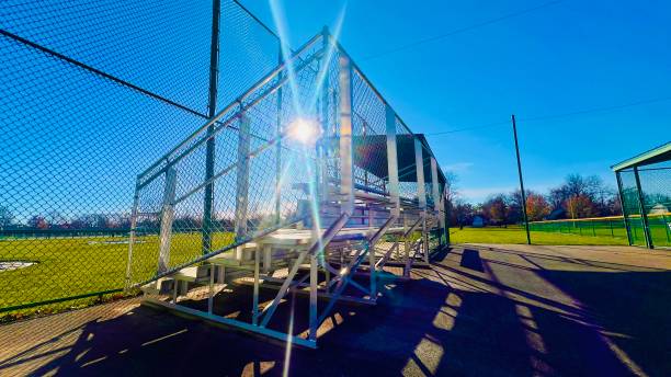 istock Bleachers on baseball field with blue sky on sunny day. 2187593547