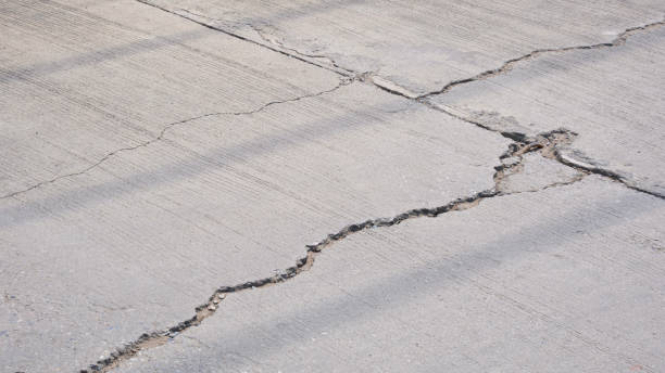 istock Broken crack lines texture on the old damaged concrete street surface 2187593639