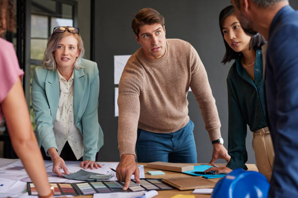 istock Group of designers and interior architects reviewing plans 2187596568