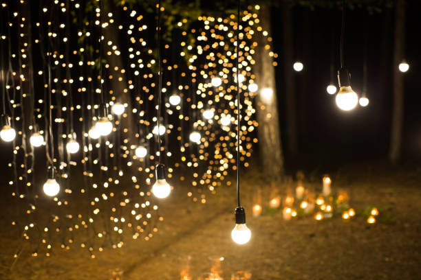 istock Wedding ceremony evening with candles and lamps in the coniferous pine forest 2187596668
