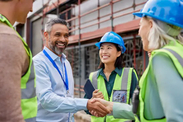 Construction worker shaking hands with foreman Construction worker shaking hands with foreman