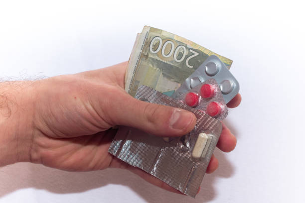 istock Pills and tablets in the hand and Serbian Dinar Banknotes. 2187601172