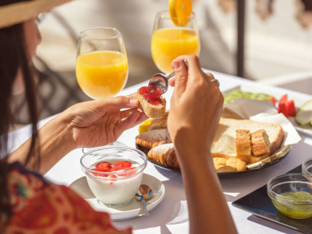 istock Unrecognizable woman applying jam on toast 2187604424