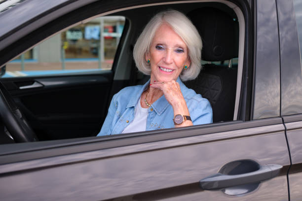 istock An elderly lady inside her car smiling at the camera showing her independence for insurance companies 2187605309