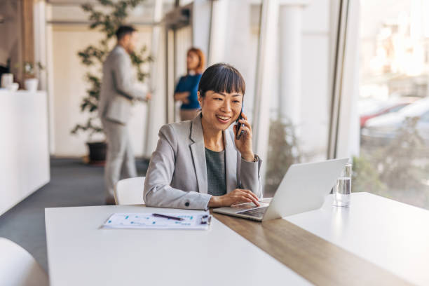 istock A smiling businesswoman making a phone call in an office 2187606280