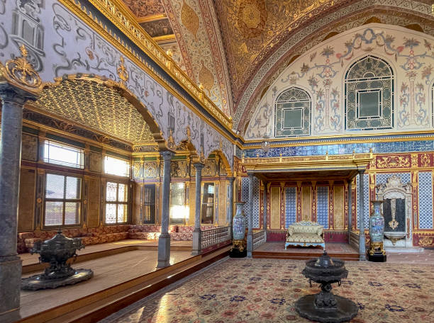 istock Istanbul, TR - Oct 23, 2024 The Imperial Hall in Topkapi Palace's Harem is its largest domed room, featuring lavish Ottoman decor, intricate tiles, gilded woodwork, and regal seating areas. 2187606746