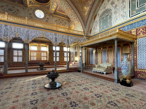 istock Istanbul, TR - Oct 23, 2024 The Imperial Hall in Topkapi Palace's Harem is its largest domed room, featuring lavish Ottoman decor, intricate tiles, gilded woodwork, and regal seating areas. 2187606749