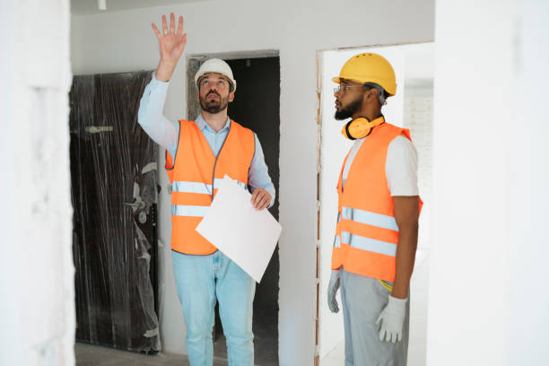 istock Civil engineer discussing the structure of the building with contractor at construction site 2187612159